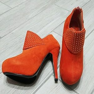 Orange suede booties with rhinestone cuffs